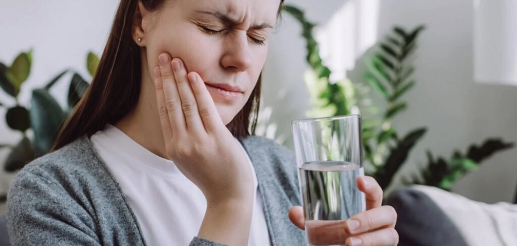 Woman using salt water rinse for wisdom tooth pain relief
